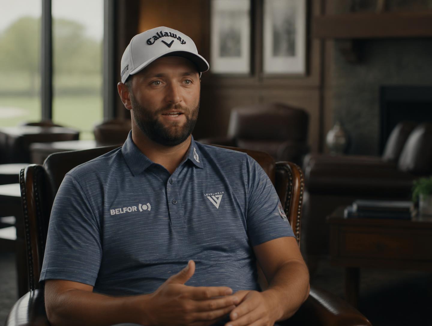 Golfer being interviewed in a clubhouse